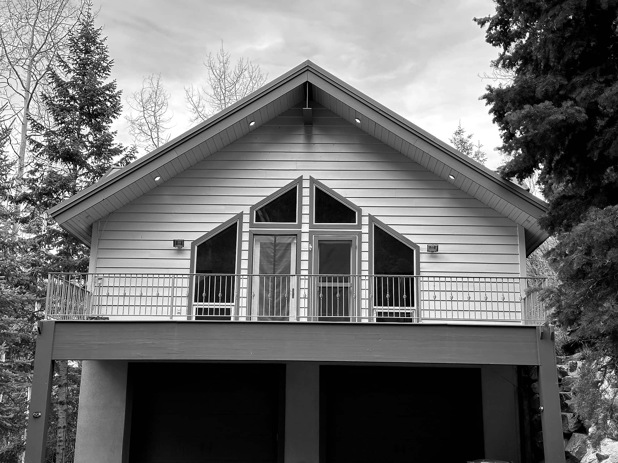 The residence seen from the drive, deck running the width of the gable