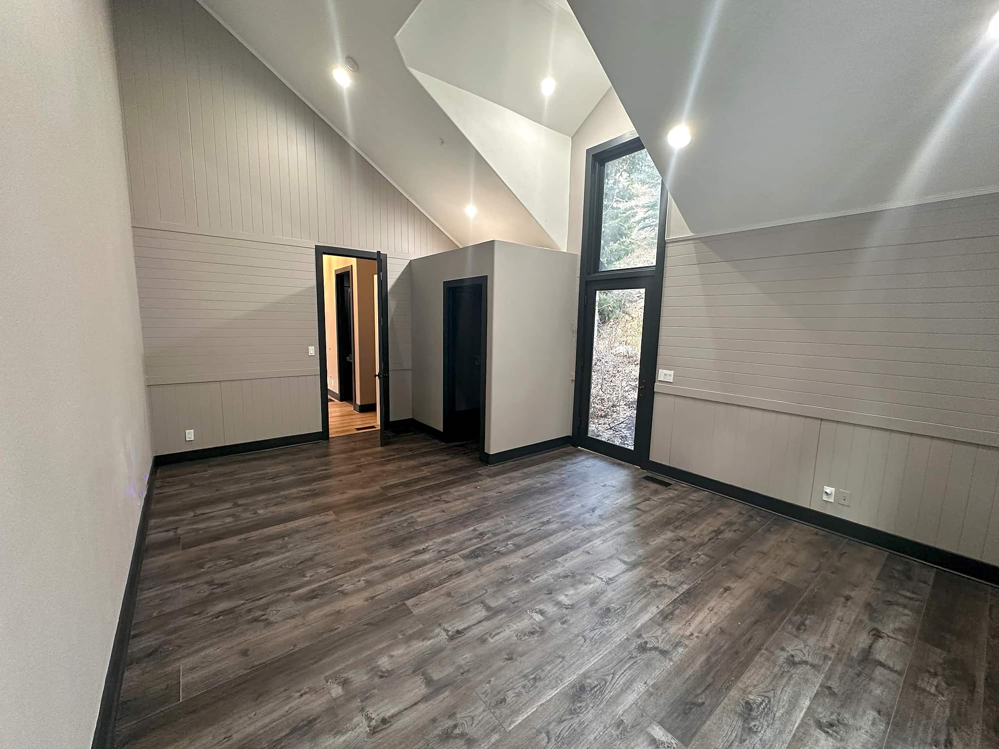 The bedroom with full-height windows onto the aspens