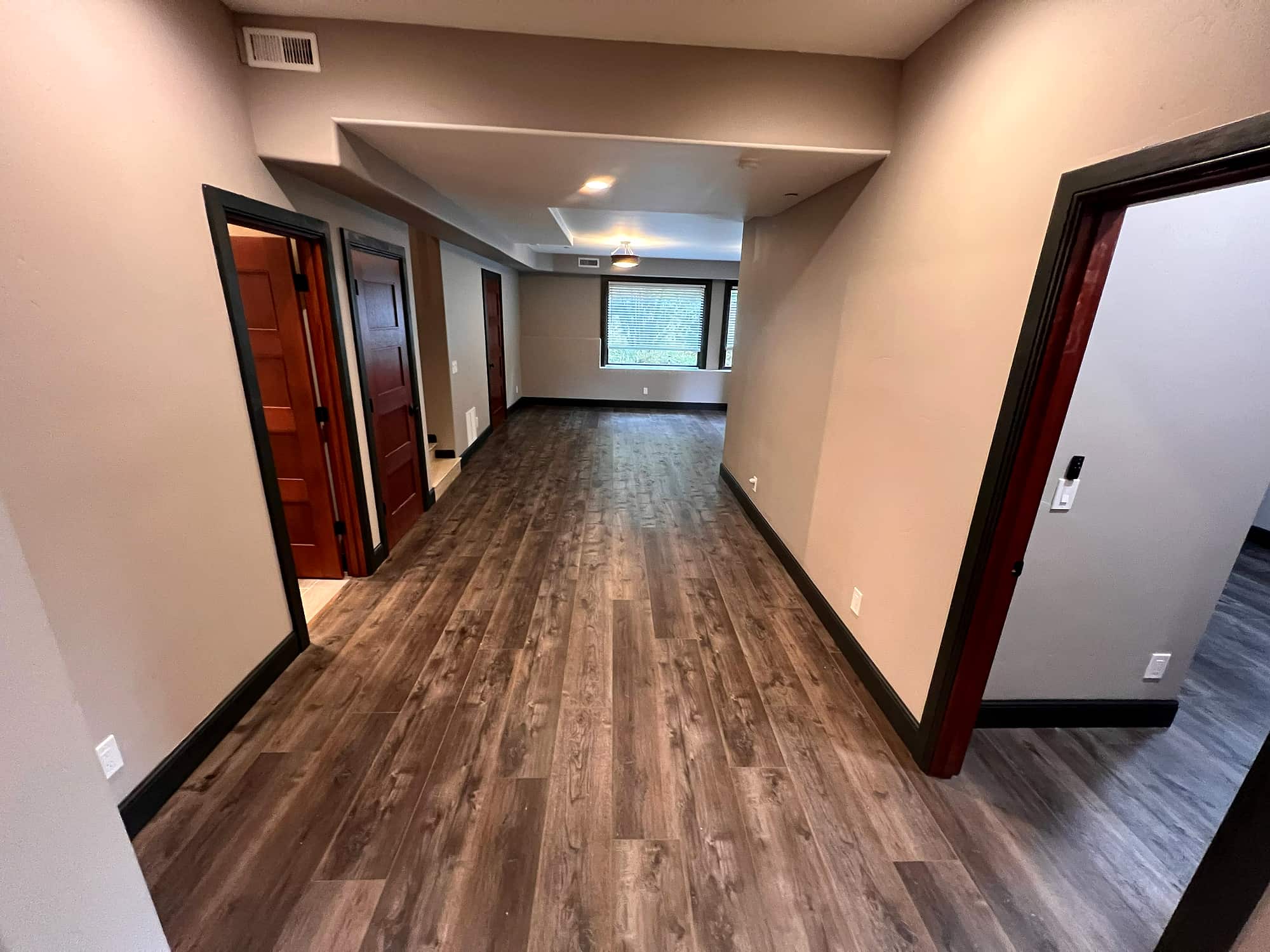 A lower-level hallway leading to the bedrooms