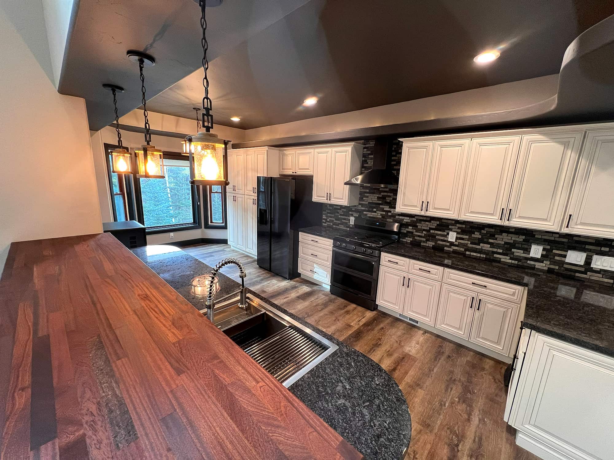The kitchen, with a mahogany island and tiled backsplash