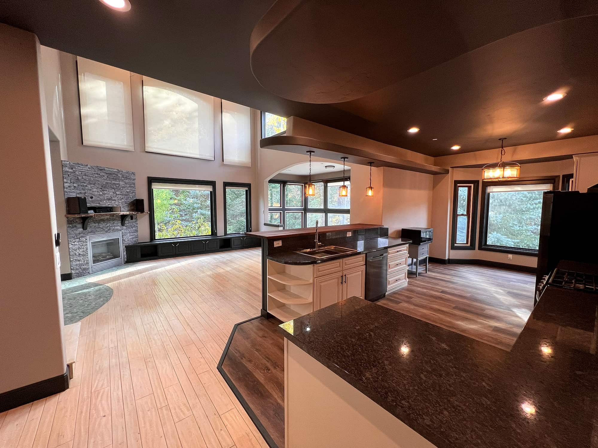 A second living area with a stone fireplace and bay window seat