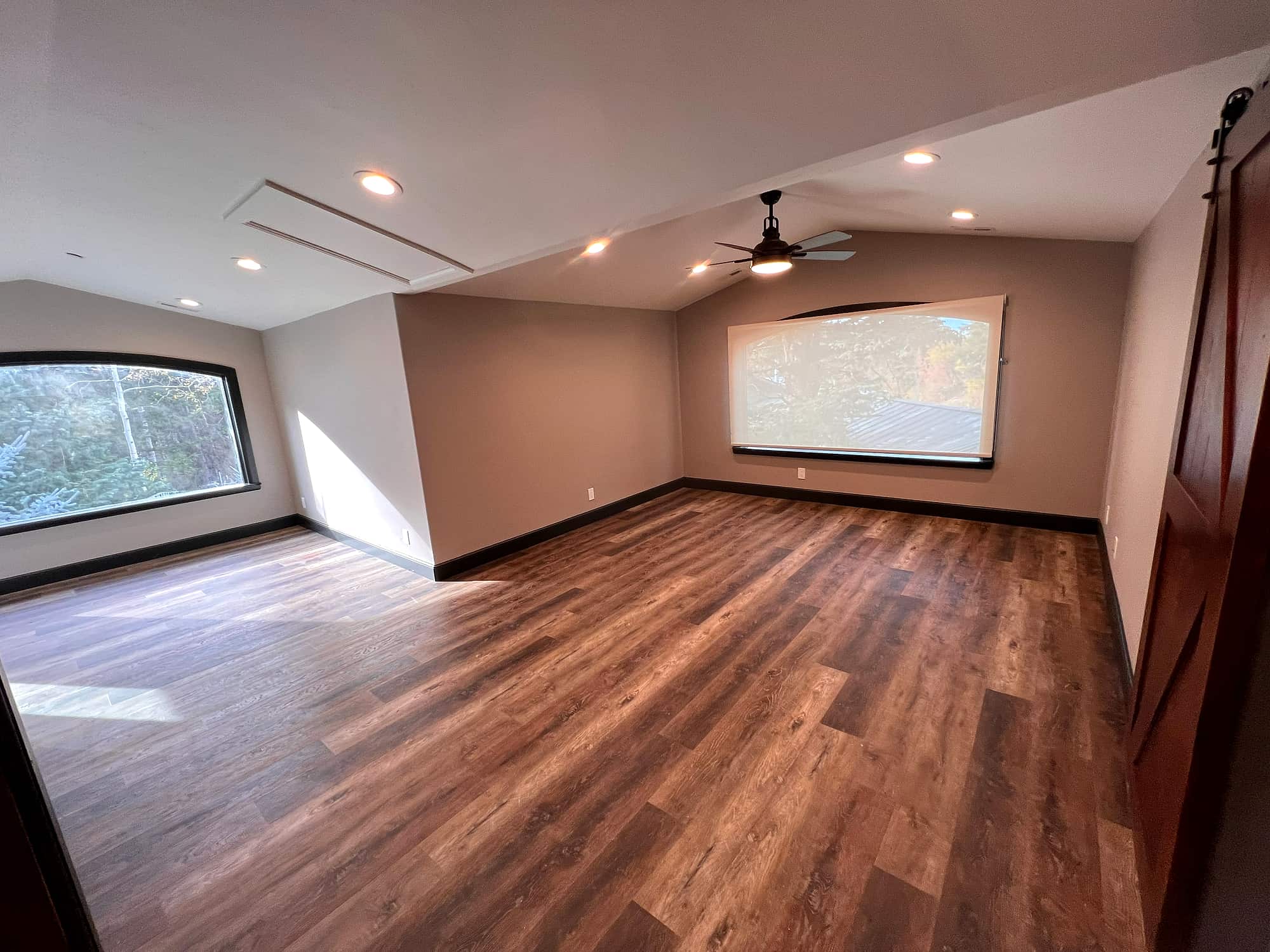 The primary suite's sitting area, with its own window and vaulted ceiling